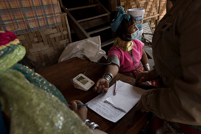 Mu Bu checks her blood pressure before being injected with the third dose of the vaccine. After two doses of the Sinopharm vaccine, the third injection of the long-awaited vaccine from the American firm Pfizer is seen as an opportunity to reopen their village to mass tourism and a return to life as it was before.