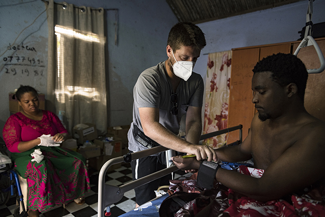 Clément, a private nurse in Mayotte, locally known as the 'doctor' visits a man suffering from lower limbs paralysis. Mayotte - 2021