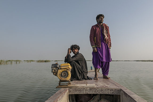 Mohamed and Imran sail across Lake Manchar. Today, with fish becoming increasingly scarce, some boats are now fitted with engines to reach distant parts of the lake.