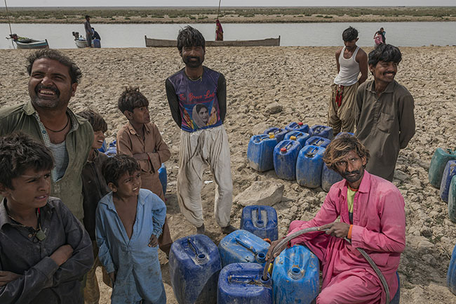 During potable water distributions, everyone waits their turn to fill their canisters. First come, first served. Here, on the shores of Lake Manchar, every drop of potable water is a treasure, every canister a victory.