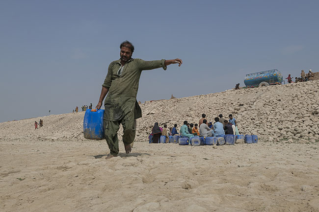 On foot or by boat, once the canisters are filled with potable water, they must still be carefully brought back to the homes.