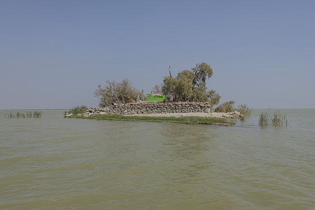 The tomb of Sheikh Dhaman, a revered Sufi saint by the Mohana community, rises from the waters of Lake Manchar.