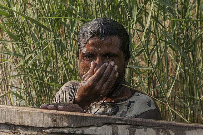 A Mohana fisherman emerges from the waters of the lake.