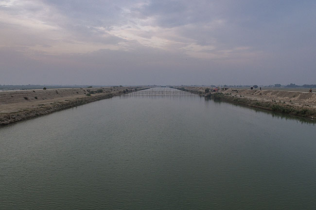 Nets are stretched over the Right Bank Outfall Drain (RBOD) to catch the birds flying over its waters — the last resource for a community struggling to survive.